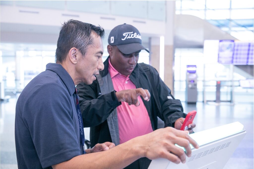 Photo Courtesy of Aira: A passenger at an airport uses Aira ASL to check in with an airline representative.